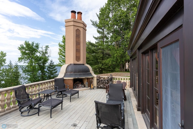 wooden terrace with exterior fireplace