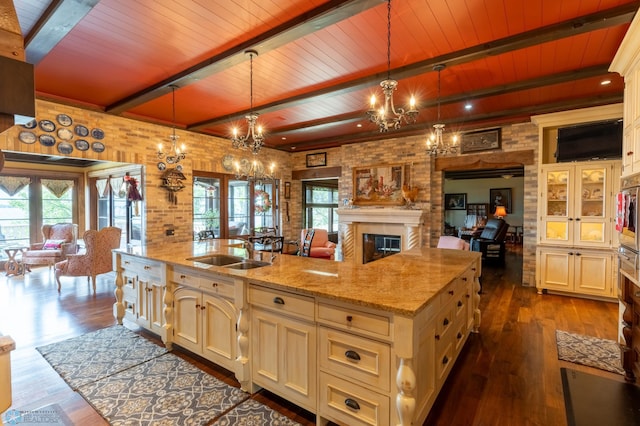 kitchen featuring a healthy amount of sunlight, beamed ceiling, and wood ceiling