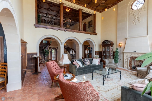 living room featuring a high ceiling and tile floors