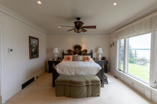 carpeted bedroom featuring ornamental molding and ceiling fan