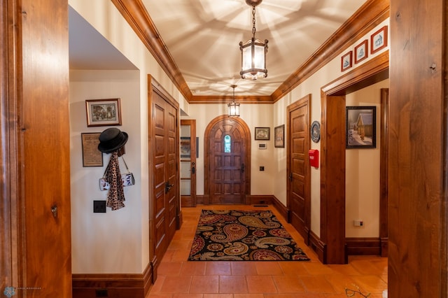 foyer entrance with tile flooring and ornamental molding