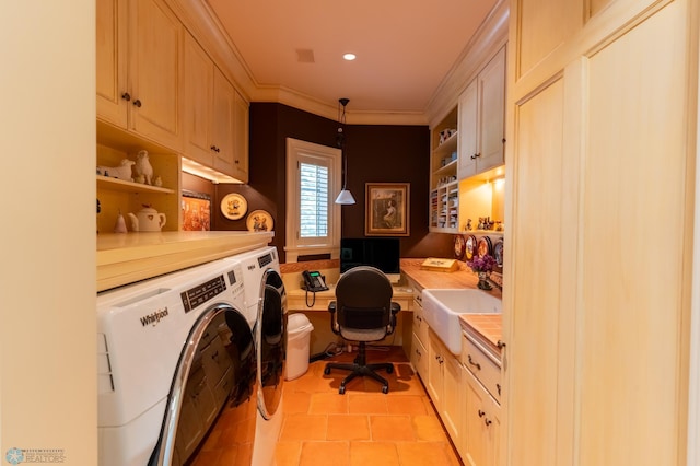 laundry room with sink, light tile flooring, cabinets, and washing machine and dryer