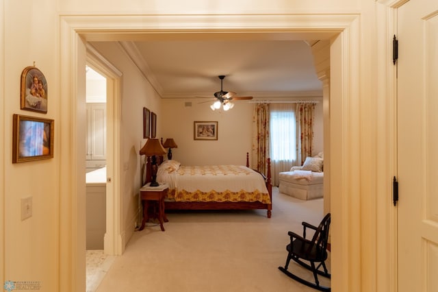 carpeted bedroom with ornamental molding and ceiling fan