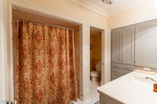 bathroom with tile flooring, crown molding, toilet, and vanity