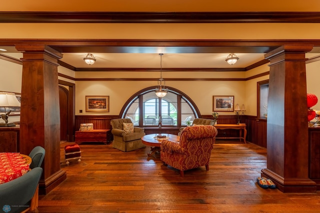 living room with crown molding, hardwood / wood-style flooring, and decorative columns