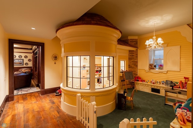 corridor featuring a chandelier and hardwood / wood-style flooring