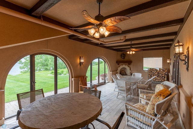 dining room with ceiling fan and beam ceiling