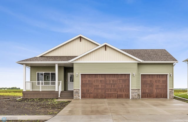 craftsman-style home featuring covered porch and a garage