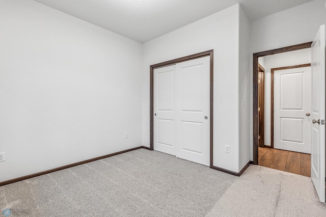 unfurnished bedroom featuring a closet and carpet flooring