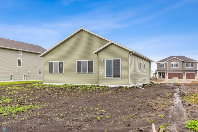 rear view of house with a garage