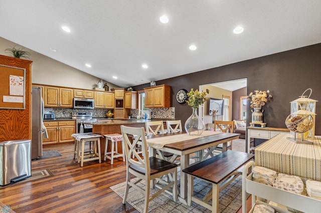 dining area featuring dark wood-type flooring and lofted ceiling