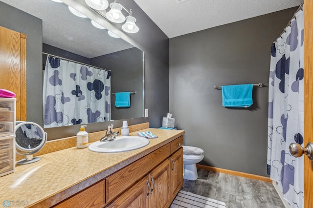 bathroom featuring toilet and large vanity