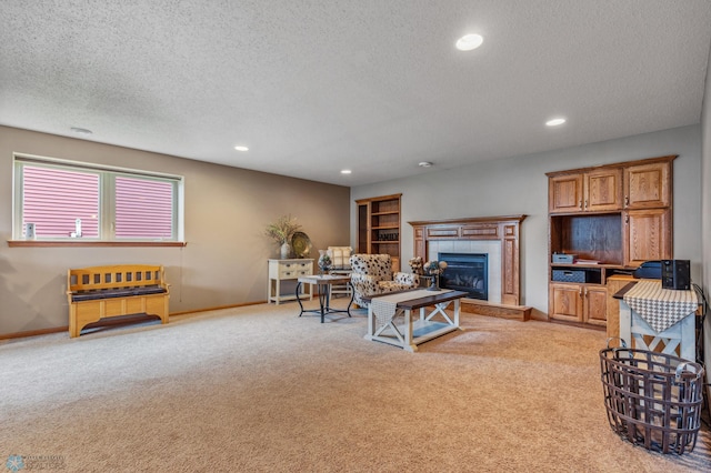 living room featuring light carpet, a tiled fireplace, and a textured ceiling