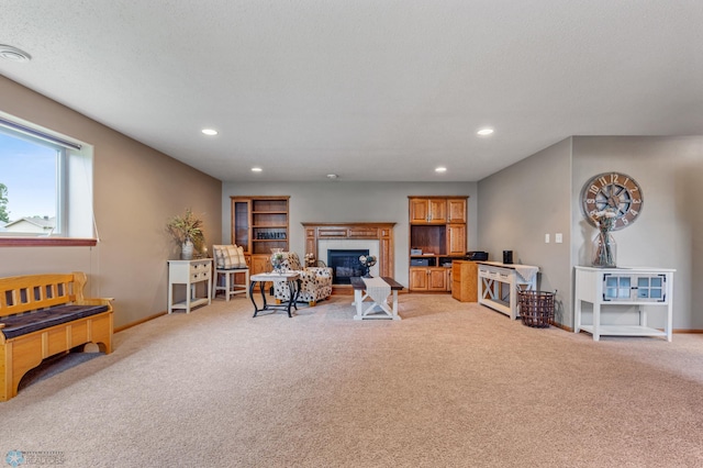 living room with a tiled fireplace and light carpet