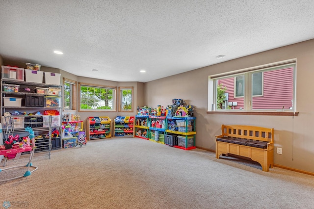 game room featuring carpet floors and a textured ceiling