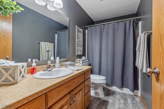 bathroom with hardwood / wood-style flooring, toilet, and vanity