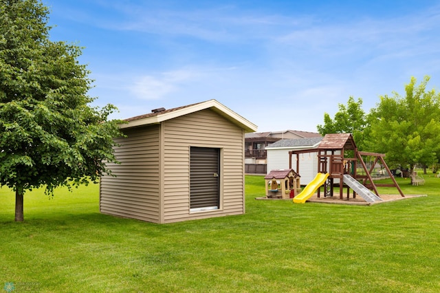 back of property featuring a playground, a shed, and a lawn