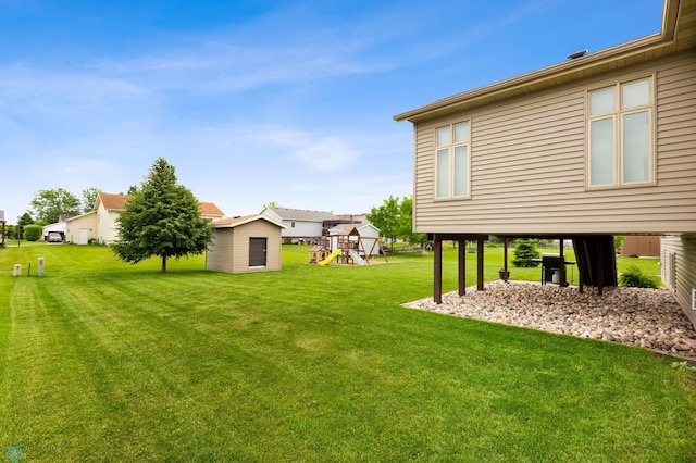 view of yard featuring a playground and an outdoor structure