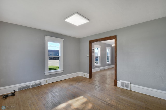 unfurnished room with wood-type flooring