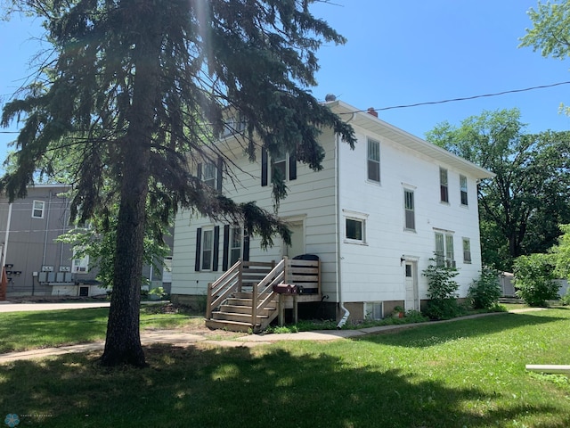 rear view of property with a lawn