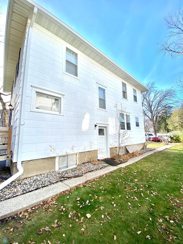 rear view of property featuring a yard