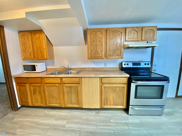 kitchen featuring sink, stainless steel range with electric stovetop, and light tile floors