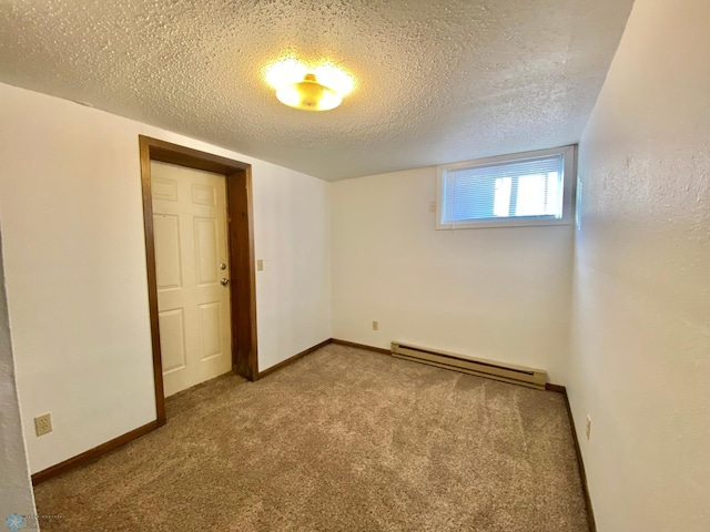 unfurnished bedroom featuring a baseboard heating unit, a textured ceiling, and carpet flooring