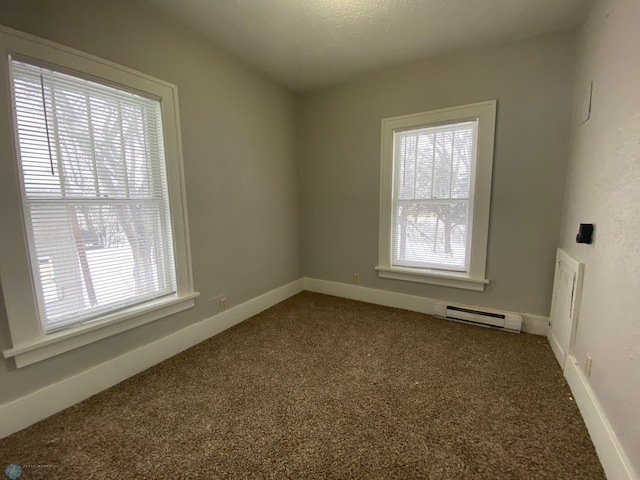 spare room with a baseboard radiator and carpet flooring