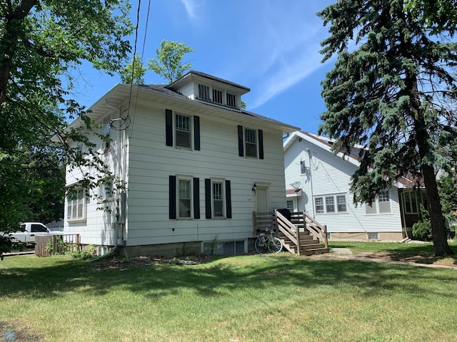 rear view of property featuring a yard