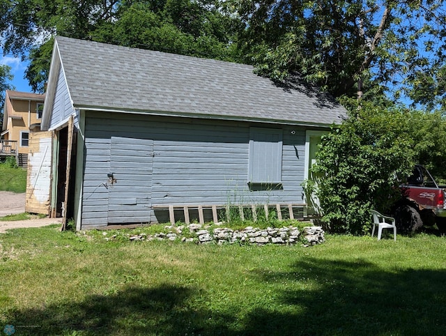 view of side of home with a lawn