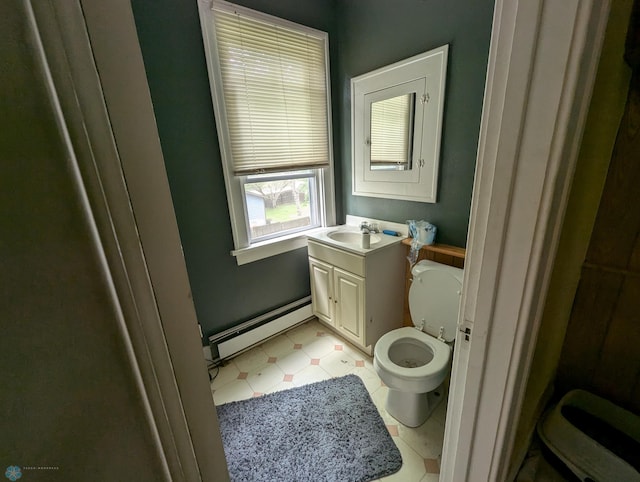 bathroom with tile flooring, a baseboard radiator, vanity, and toilet