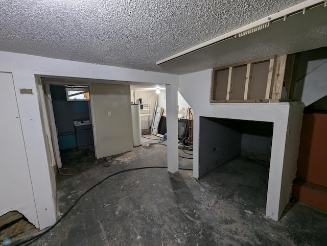 interior space with a textured ceiling and water heater