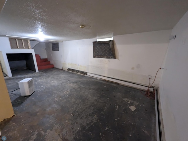 basement featuring a textured ceiling