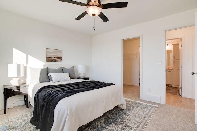 tiled bedroom with ceiling fan, a closet, and a spacious closet