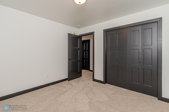 unfurnished bedroom featuring carpet and a closet