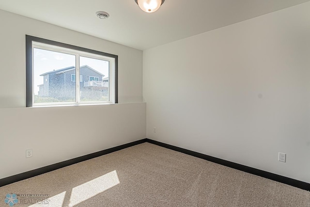 unfurnished room featuring carpet