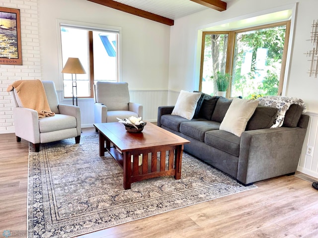 living room with vaulted ceiling with beams and hardwood / wood-style flooring