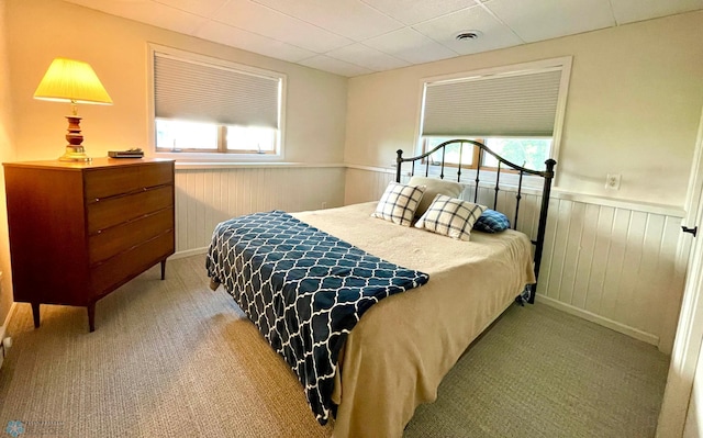 bedroom with carpet flooring and multiple windows