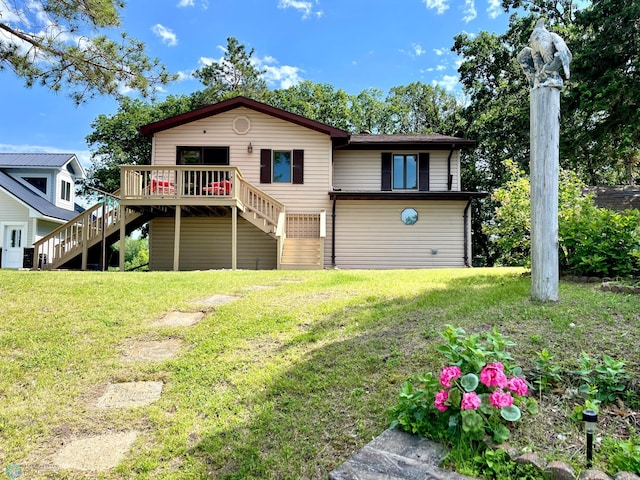 rear view of property with a yard and a deck