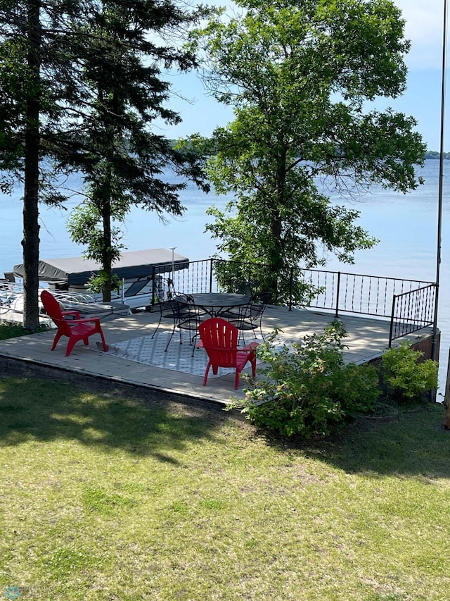 view of yard with a deck with water view