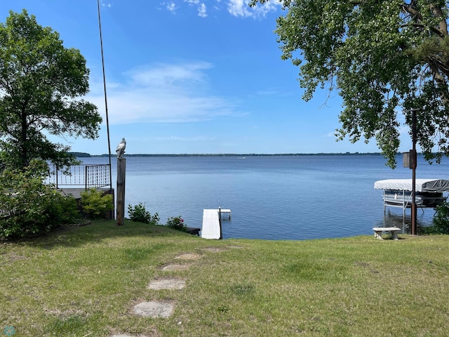 exterior space with a water view and a yard