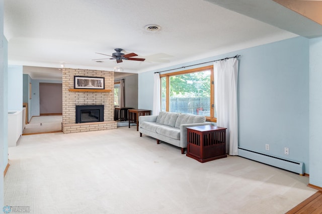 carpeted living room with brick wall, a fireplace, ceiling fan, a baseboard heating unit, and a textured ceiling