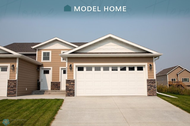 craftsman house featuring a front yard and a garage