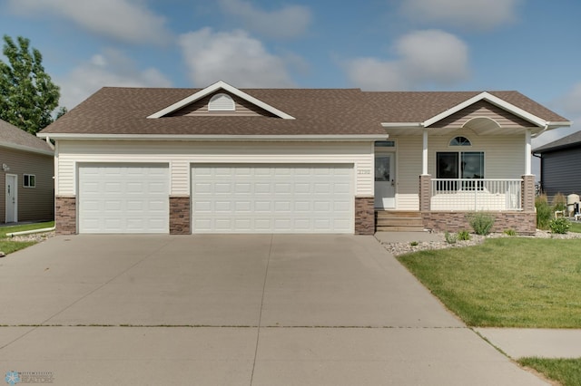 view of front of home with a garage, covered porch, and a front lawn