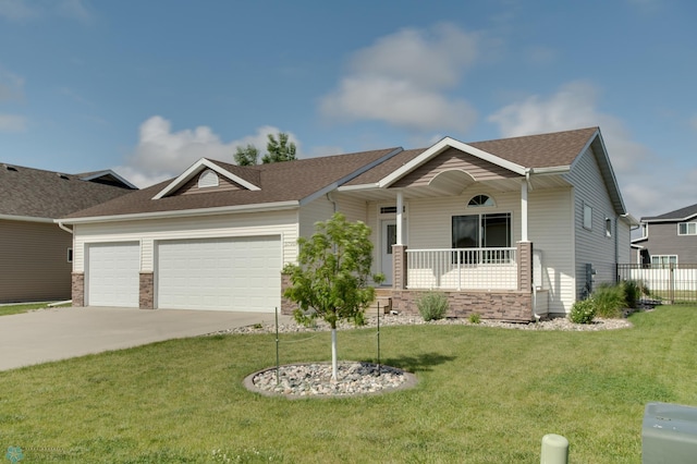 view of front facade featuring a garage, a front yard, and covered porch