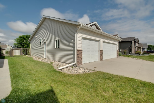 view of home's exterior with a garage and a yard