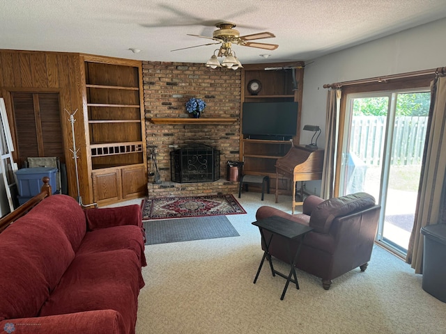 carpeted living room featuring a textured ceiling, ceiling fan, and a brick fireplace