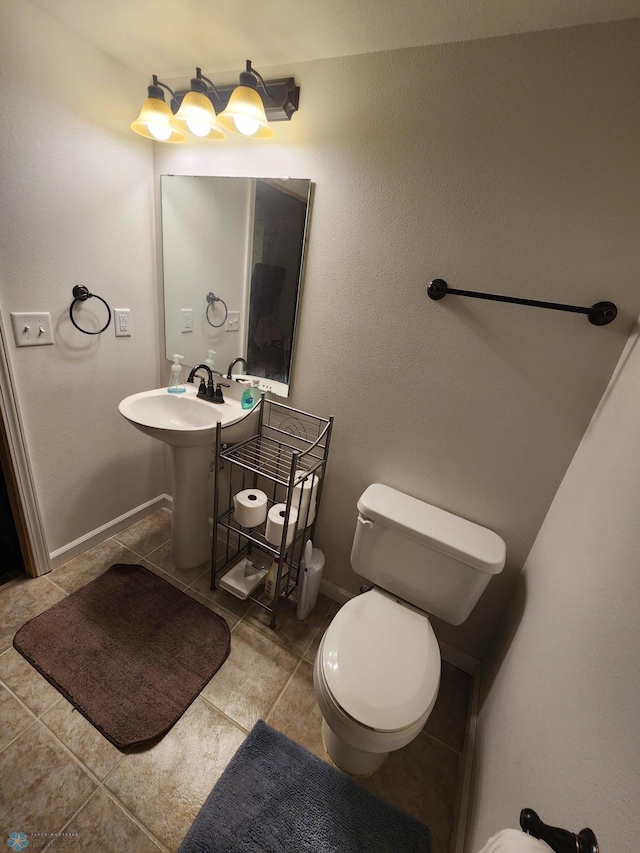 bathroom featuring toilet and tile patterned floors