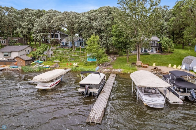 dock area with a water view and a yard