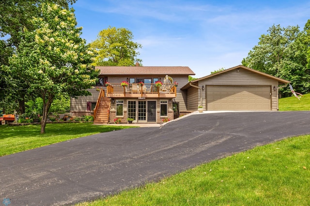 view of front of home featuring a garage, a wooden deck, and a front lawn